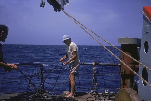 Russell Raitt (right) and George G. Shor slacking hydrophone cables. Onboard R/V Thomas Washington, Indopac Expedition. September 14, 1976