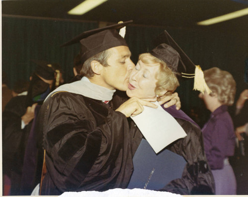 Seaver Graduation--President Banowsky kissing the honorary doctorate recipient (Color)
