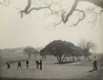 Golfers at country club, with oak trees