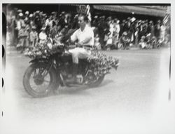 Man riding a motorcycle in the Rose Parade