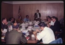Group at conference table with boater hats