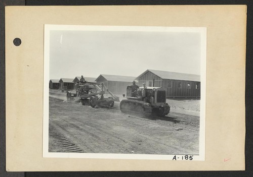 Poston, Ariz.--Site No. 2--Leveling the streets with tractors at this War Relocation Authority center for evacuees of Japanese ancestry. Photographer: Clark, Fred Poston, Arizona