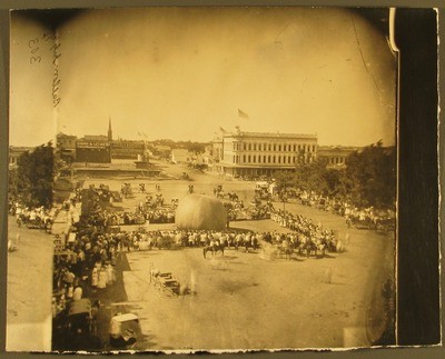 Stockton - Centennial Celebration: Balloon Ascension, Mansion House, Kuhn and Lecher's Cigars, J. H. Condit and Co. and Jones and Hewlett in background