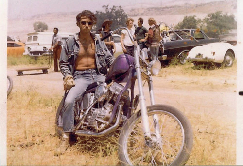 Chuck Waters posing in character as a motorcycle gang member