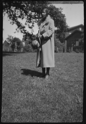 Woman in coat standing in yard