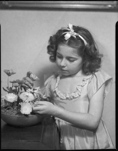 Sylvia Arslan arranging flowers, [1939-1940?]