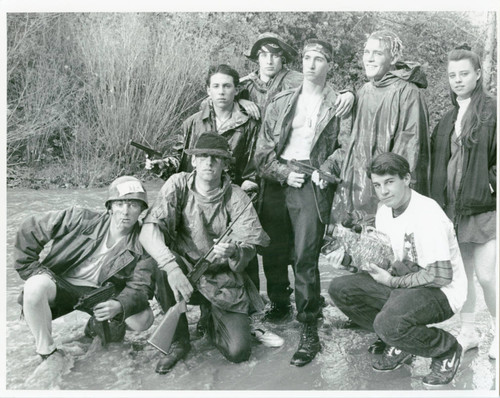 Amateur filmmakers posing in creek bed