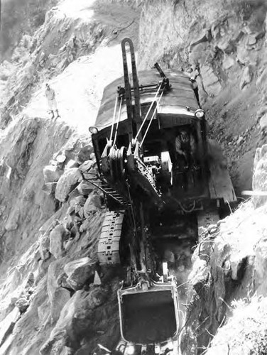 Huge tractor shovels, operated by 'diesel' engines, used for road construction in the mountainous Cozy Dell sector
