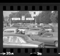 Lines of automobiles waiting at car wash-gas station during oil crisis in Los Angeles, Calif., 1974