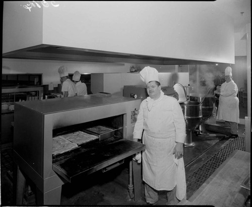 Chef with food in ovens