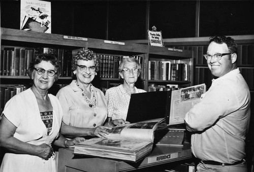 Four people at the Reference Desk of the Banning Public Library in Banning, California