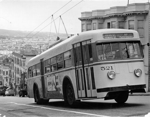 [Municipal Railway trackless trolley 'E' line, car number 521 ascending hill]