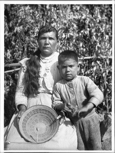 Yokut Indian women basket maker and her son home from school, Tule River Reservation near Porterville, California, ca.1900