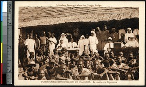 Dispensary staff and patients pose in front of the building, Niangara, Congo, ca.1900-1930