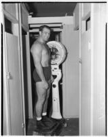 Wrestler and football player Bronko Nagurski on the scale before a wrestling match at Wrigley Field, Los Angeles, August 11, 1937
