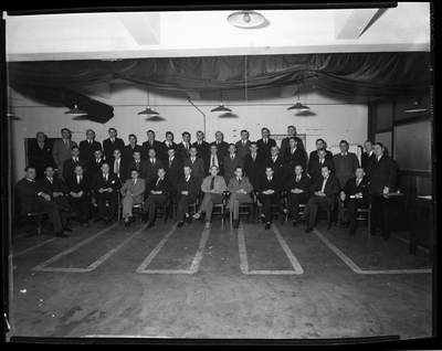 Group portrait of men in meeting room