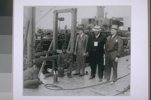 Kaiser shipyard, Richmond. L to R: [Cottrell Laurence] Dellums, Spencer Jordan, Head, Negro Boiler makers local, Ben Watkins, P.R. Officer for Kaiser