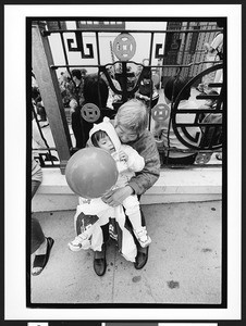 Old woman of Chinese origin holding a balloon and young child of Chinese origin, Chinatown, San Fracisco, California, 2002