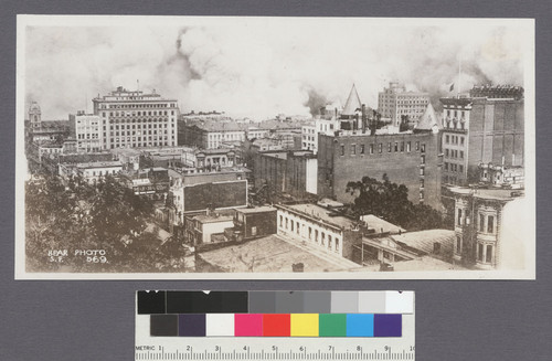 [View of fire looking southeast from Nob Hill. Spires of California Hotel and Theatre, right.]