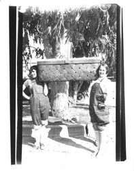 Two women with large basket of eggs, Petaluma, California, about 1930