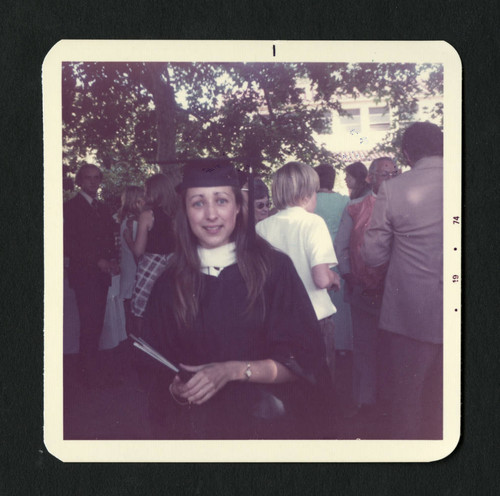 Scripps College student holding her diploma after graduation, Scripps College