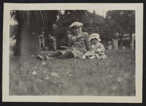 Boy and young girl sitting outside