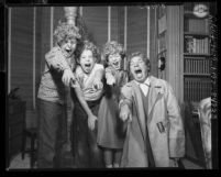 Harpo Marx and three of his children joking around wearing Harpo wigs in Los Angeles, Calif., 1954