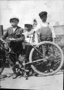 3 boys with bicycle