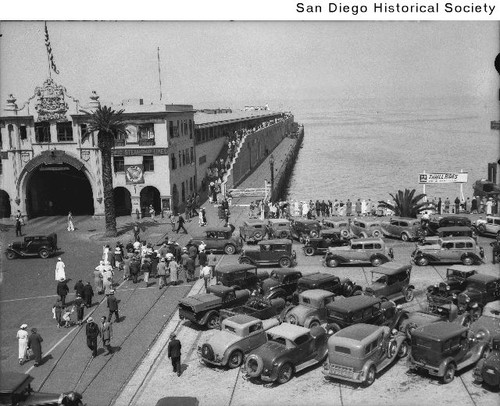 Automobiles and people at the Broadway Pier for the return of the fleet