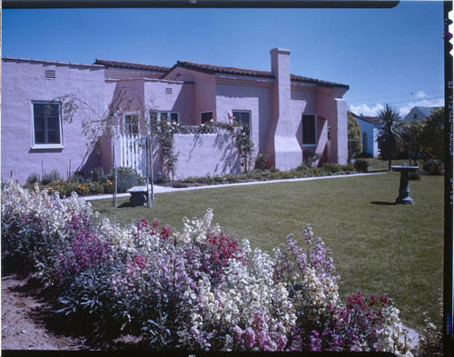 [Unidentified residential exteriors and landscaping]. Spanish-style, lawn