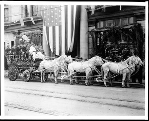 Horse-drawn Los Angeles Chamber of Commerce float draped in flowers during a Shriners Convention