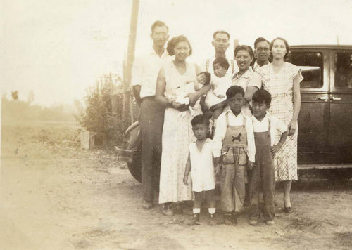 Group photo in front of a car including Dorothy Siu holding Gilbert