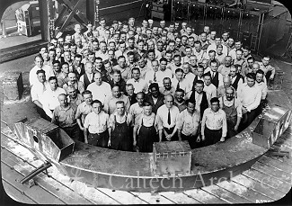 Westinghouse workers pose inside a section of the telescope tube