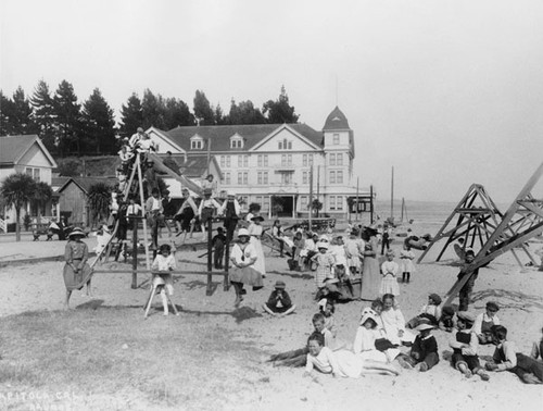 Children playing on the Capitola beach, with Hotel Capitola
