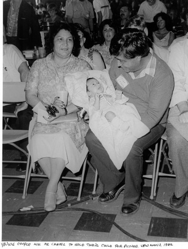Cesar Chavez holding a baby on his lap