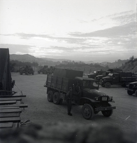 Depot of military vehicles under sunset
