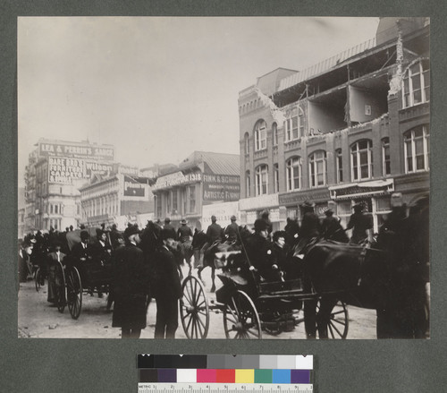 [Civilian traffic and soldiers passing on street.]