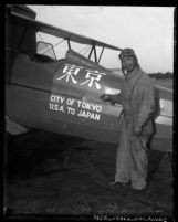 Zensaku Azuma next to the plane he flew from the United States to Tokyo, 1930