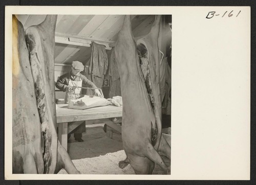 A view in the slaughter house and butcher shop. Hogs, which are grown in the evacuee run hog farm, are slaughtered here, for consumption by the residents of the center. Photographer: Stewart, Francis Newell, California