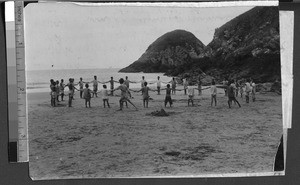 Chinese boys hold hands in a circle on a beach, Fuzhou, Fujian, China, ca. 1920