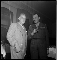 Early family (Eanly? Easly?): [two men, one a French Liaison Officer in uniform, at dinner probably in Alsace]