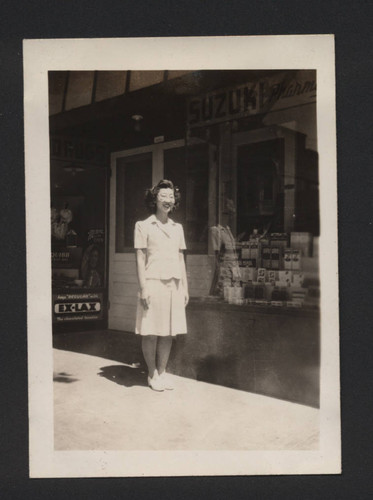 Photograph of Suzuki family member in front of Suzuki Pharmacy