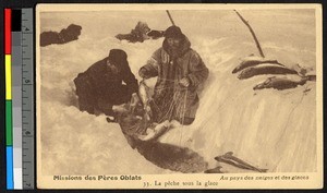 Two missionary fathers ice fishing on a snow-covered lake, Canada, ca.1920-1940