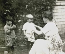 Wilfred Everett Bixby, Jr. in boxing gloves, standing with his mother and an unidentified boy at the Bixby house, 415 Perkins Street, Oakland, California, 1912