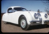 Bill Emerson with his white Jaguar automobile