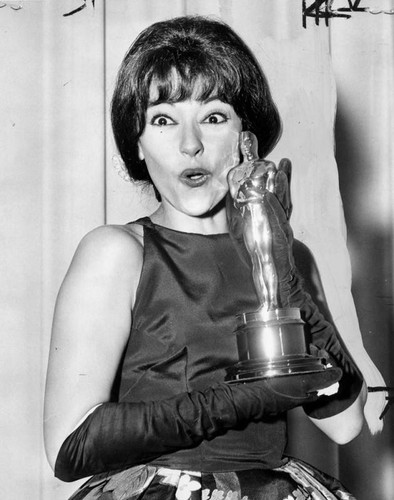 Rita Moreno holding an Oscar