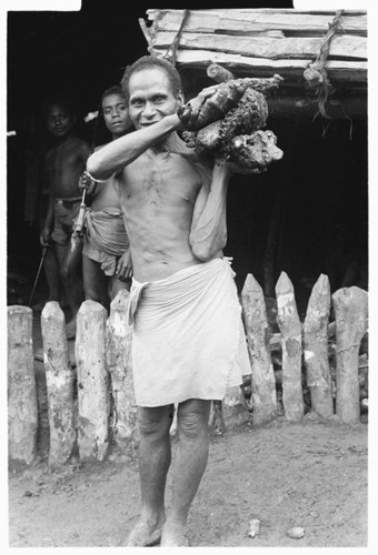 Man carrying pork on shoulder