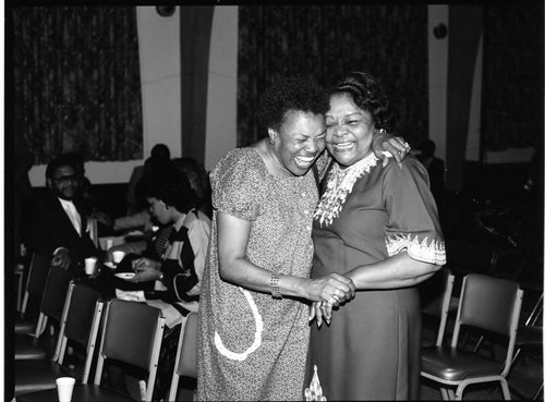 African American women laughing together at a meeting, Los Angeles, 1984