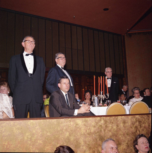 Three unidentified men standing for recognition at Pepperdine's Birth of a College dinner, 1970