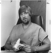 Dr. Fred George, foot surgeon holding model of foot